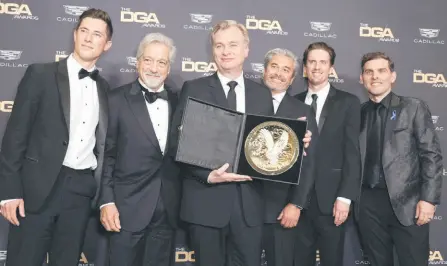  ?? — AFP file photo ?? Nolan (centre) and team pose in the press room during the 76th Directors Guild of America Awards at The Beverly Hilton on Feb 10, 2024 in Beverly Hills, California.