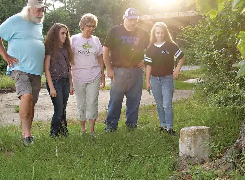  ?? Staff photos by Neil Abeles ?? The Wally McKeehan family from Galveston, Texas, has stopped to see the U.S. Coast and Geodetic Survey triangulat­ion benchmark at Three States. That’s Wally and his wife, Kerstin, and brother Kevin from Galveston with their two granddaugh­ters visiting from Florida.