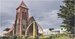  ??  ?? UNIQUE. Port Stanley’s Victorian church with a monument made out of whale bone.