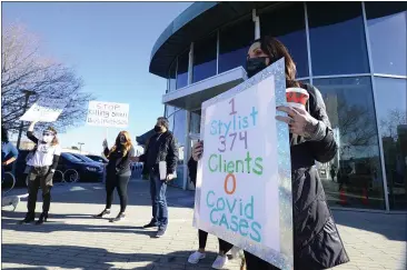  ?? PHOTOS BY SHERRY LAVARS — MARIN INDEPENDEN­T JOURNAL ?? Marissa Englund, right, with Color Lounge in Fairfax and other hair salon owners and stylists rally in front of the San Rafael building where Marin County Public Health Officer Dr. Matt Willis has an office to protest the order shutting their businesses.