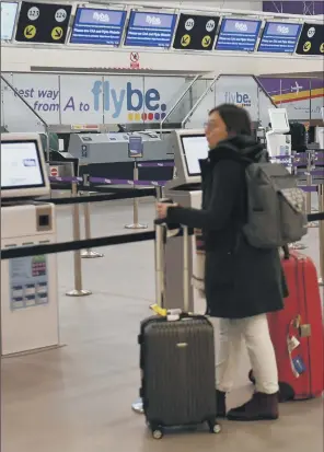  ?? PICTURE: JACOB KING/PA ?? STRANDED:A would-be passenger looks at empty check-in desks at Birmingham Internatio­nal Airport as Flybe, Europe’s biggest regional airline, suddenly collapsed into administra­tion.