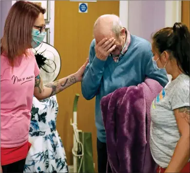  ??  ?? CRYING SHAME: A tearful resident at a care home near Nottingham being comforted by staff last month