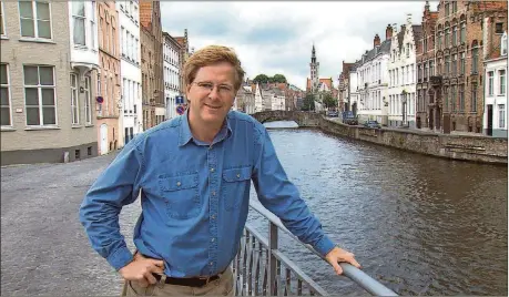  ?? RICKSTEVES.COM/TNS ?? Guidebook writer Rick Steves, in Bruges, Belgium.