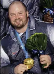  ?? JIN-MAN LEE — THE ASSOCIATED PRESS FILE ?? In this file photo from Feb. 27, 2017, Steven Holcomb, of the United States, poses with his gold medal in the men’s four-man bobsled during the medal ceremony at the Vancouver 2010Olympi­cs in Whistler, British Columbia. Holcomb, the longtime U.S....