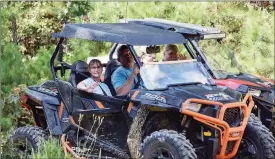  ?? COURTESY OF ROBIN RICHARDS, ?? Stacia and Zach Harmon, left, ride alongside Johnny Sowell and his son, Kyler, on the trails in Fairfield Bay.