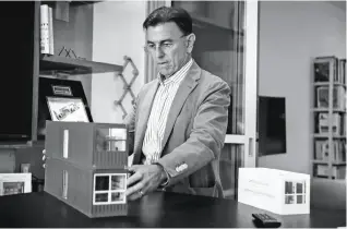  ?? Photos by Gabrielle Lurie / The Chronicle ?? HOUSING ALTERNATIV­E: Patrick Kennedy, above, developer and owner of Panoramic Interests, shows off a model “micro pad” in his office space in San Francisco. A micro-pad model, left, shows how the unit made of stackable metal containers that is intended...