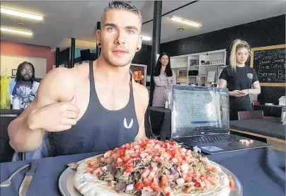  ?? SUBMITTED PHOTO/JOEL HANSEN ?? Former Wellington resident Joel Hansen tackles a six-pound donair at Alexandra’s Pizza in Sydney, N.S. Hansen has participat­ed in about 12 food challenges.