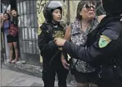  ?? Martin Mejia Associated Press ?? POLICE comfort a woman after she was confronted by anti-government protesters in Lima, Peru.