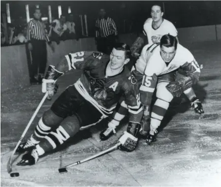  ?? AP FILE PHOTO ?? Stan Mikita of the Chicago Blackhawks pulls away from Ted Lindsay of the Detroit Red Wings during a Feb. 24, 1965 NHL game in Chicago. Mikita, a nine-time all-star who played his entire 21-year NHL career with the Blackhawks, died on Tuesday.