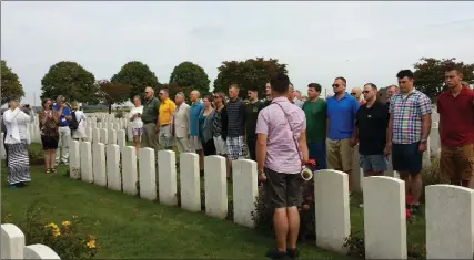  ?? TIM FLETCHER, SPECIAL TO THE HAMILTON SPECTATOR ?? Soldiers of the RHLI stand at attention, front, with members of the RHLI Dieppe tour gathered around them after Cpl. Brian Vautour, a member of the RHLI band, sounded the “Last Post” on the Vallance bugle at the Poelcapell­e Military Cemetery in Belgium...