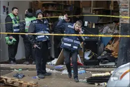  ?? KEVIN HAGEN — THE ASSOCIATED PRESS ?? Responders work to clean up the scene of Tuesday’s shooting that left multiple people dead at a kosher market on Wednesday in Jersey City, N.J.