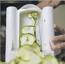  ??  ?? A SPIRALIZER spins out ribbons of such vegetables as zucchini — the basis for fresh, light, pasta-like dishes.