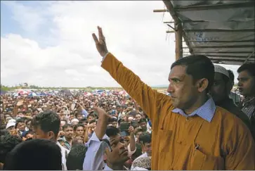  ?? Allison Joyce Getty I mages ?? MOHIB ULLAH, right, and other refugees in Bangladesh mark the Rohingya crisis’ second anniversar­y.