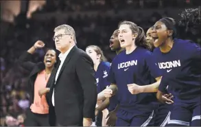  ?? Sean Rayford / Associated Press ?? UConn coach Geno Auriemma watches from the sideline while the bench celebrates a defensive play during the first half on Monday, in Columbia, S.C.