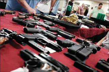  ?? SPENCER PLATT/GETTY IMAGES/TNS ?? Guns are for sale at a gun show in 2018in Naples, Fla.