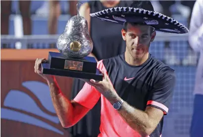  ?? Getty Images ?? Juan Martin del Potro poses with the trophy after defeating Kevin Anderson in the Mexican Open final. —