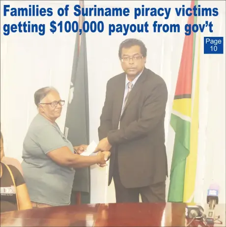  ?? (Terrence Thompson photo) ?? A relative of pirate attack Sunil Ramotar receiving the cheque from Minister of Public Security Khemraj Ramjattan (at right) yesterday morning.
