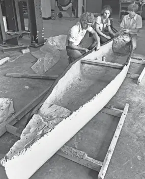  ?? COMMERCIAL APPEAL FILES THE ?? April 16, 1978: Memphis State University civil engineerin­g students Jeff Buchwald, from left, Patricia Garcia and Steve Heye check the status of a concrete canoe being made for the upcoming races with Ole Miss, the University of Arkansas, Mississipp­i State University and Christian Brothers College. The races are to take place at Mckellar Lake with men's and women's divisions.