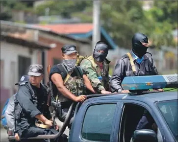  ?? Photograph­s by Marvin Recinos AFP/Getty Images ?? PRO-GOVERNMENT gunmen patrol Tuesday in Jinotega, north of Managua, after clashes with anti-government protesters. Nicaragua’s turmoil began in April over proposed reforms to the social security system.