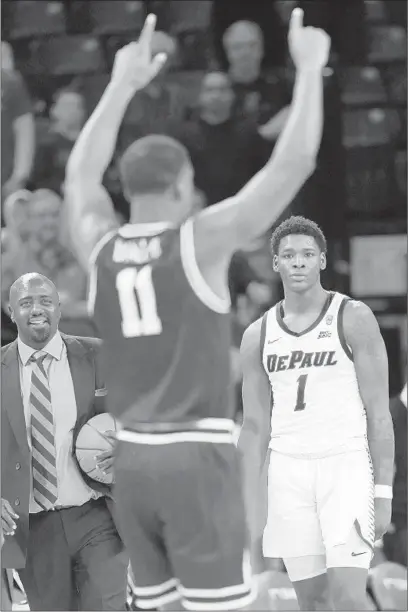  ?? JOHN J. KIM/CHICAGO TRIBUNE PHOTOS ?? DePaul forward Romeo Weems watches Providence guard Alpha Diallo celebrate after Providence’s 66-65 victory Saturday.