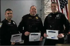  ?? KRISTI GARABRANDT — THE NEWS-HERALD ?? Willowick Police officers, Patrolman Jacob Cook, Sgt. Dan Hirz and Patrolman Keith Lawrence were recognized by the Lake County Chiefs of Police Associatio­n on April 4, for their lifesaving actions on Jan. 12 when they pulled a 75-year-old man from a...