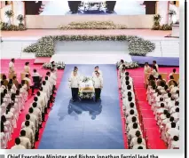  ?? ?? Chief Executive Minister and Bishop Jonathan Ferriol lead the church council members in carrying the casket from the complex to the mausoleum.