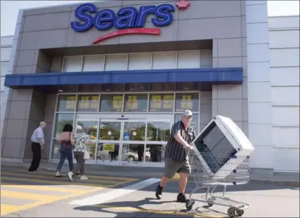 ?? RYAN REMIORZ, THE CANADIAN PRESS ?? Sears Canada is losing money on a weekly basis but will have enough liquidity to fund business to Nov. 7, subject to agreement of its restructur­ing lenders.