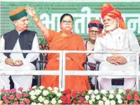  ?? PHOTO: PTI ?? PM Narendra Modi with Rajasthan Chief Minister Vasundhara Raje and MoS Arjun Ram Meghwal during ‘Vijay Sankalp Sabha’ in Ajmer on Saturday