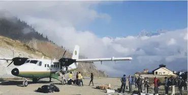  ??  ?? Clockwise from top left: Lake Phoksundo; the village of Ringmo; entrance to Tshawa Bon Monastery; Gavin Anderson, centre, with villagers; visitors have to take two flights from Kathmandu to get to Dolpo