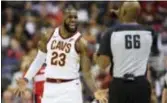  ?? NICK WASS — THE ASSOCIATED PRESS ?? Cleveland’s LeBron James (23) reacts to a call to referee Haywoode Workman (66) during the first half Friday in Washington.