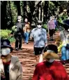  ??  ?? People take a walk as they wear masks to avoid the spread of the coronaviru­s disease (COVID-19) at a park in Seoul