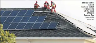  ?? Picture: MARK
ANDREWS ?? SEEING LIGHT:
Eskom workers install solar panels at the head
office in Beacon Bay