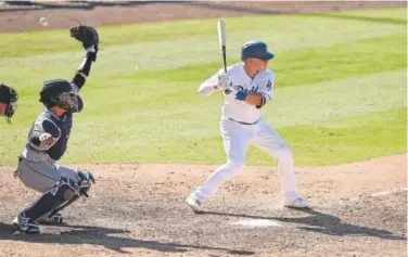  ?? Kevork Djansezian, Getty Images ?? Rockies catcher Tony Wolters reaches for a wild pitch thrown by reliever Adam Ottavino during the seventh inning of Sunday’s game at Dodger Stadium. Batting for L.A. is Enrique Hernandez. Ottavino had four wild pitches.