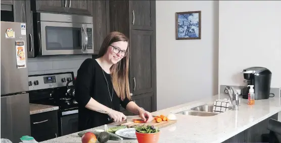  ?? CHRISTINA RYAN ?? Carly Keuben just moved into her new townhome at Vantage Fireside in Cochrane and loves the space and cabinetry in her kitchen.