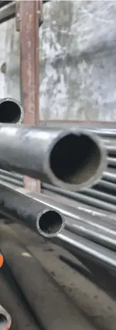  ?? Reuters ?? A worker stacks steel pipes in Ahmedabad, India. The country exported 900,000 tonnes of steel to the US last year