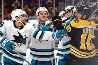  ?? Maddie Meyer/Getty Images ?? Mario Ferraro of the Sharks battles A.J. Greer of the Bruins during the third period at TD Garden in Boston. The Bruins won their fifth straight and improved to 22-1-3 at home.