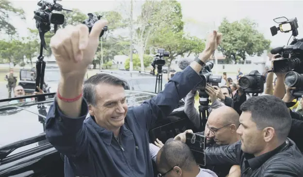  ?? PICTURE: FERNANDO SOUZA/GETTY IMAGES ?? 0 Far-right congressma­n Jair Bolsonaro gives the thumbs up after casting his vote in the first round of presidenti­al voting in Brazil