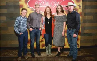  ?? MONICA SCHIPPER/GETTY IMAGES ?? During the COVID-19 pandemic, Ree Drummond (center, in 2017) saw a lot more of sons Todd (from left), daughter Paige and husband Ladd. With teenagers to feed, she said, “It’s hilarious how much less further the groceries stretch.”