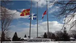  ?? ALICE CHICHE/AFP/GETTY IMAGES ?? Flags fly at half-staff at Laval University, where the accused killer was a student.