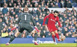  ?? REUTERS ?? Liverpool forward Mohamed Salah scores their second goal against Everton on Wednesday.