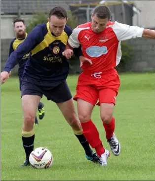  ??  ?? Graham Maloney of Rosslare Rangers and Graeme Healy of Kilmore battle for the ball.