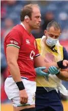  ?? Picture: Stu Forster/Getty ?? Alun Wyn Jones is led from the pitch after being injured against Japan