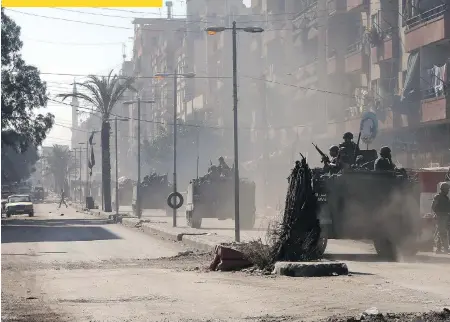  ?? JOSEPH EID/AFP/GETTY IMAGES ?? Lebanese army soldiers patrol Syria Street in Tripoli, Lebanon, in 2013. Area hostilitie­s have roots stretching back to Lebanon’s civil war of 1975-90 and they have become far more acute because of the Syria’s own civil war.