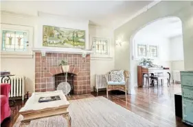  ??  ?? PIatt Sotheby's Internatio­nal Realty
The living room of the house at 3259 Pinehurst Ave. in Dormont has original stained-glass windows and a decorative fireplace.