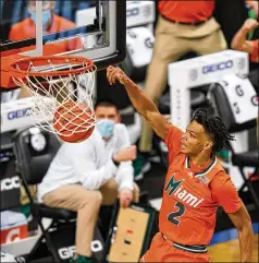  ?? GERRY BROOME/ASSOCIATED PRESS ?? Miami guard Isaiah Wong slams home a dunk during the second half of the win over Pittsburgh in Greensboro, N.C., at the Atlantic Coast Conference Tournament. Wong scored 20 points, including key late free throws, to lead five Hurricanes starters in double figures.