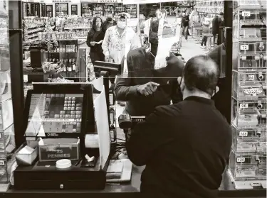  ?? Photos by Elizabeth Conley / Staff photograph­er ?? Customers buy lottery tickets from employee Nizam Uddin at Lucky Rudy’s in Rosenberg. Monthslong growth in Texas Lottery revenue culminated the first week of January when scratch ticket sales surpassed $133 million.