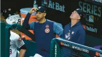  ?? GETTY ?? Astros bench coach Alex Cora, left, and manager A.J. Hinch stand in the dugout during the fifth inning against the Dodgers in Game 5 of the 2017 World Series at Minute Maid Park in Houston.