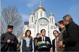  ?? Sergei Chuzavkov/AFP/Getty Images ?? Fumio Kishida visits the site of a mass grave in the town of Bucha, Ukraine Photograph: