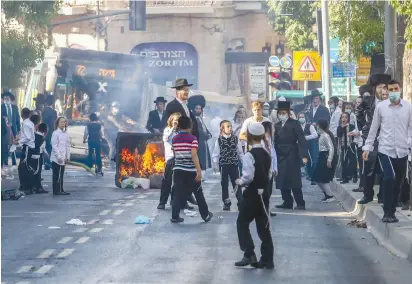  ?? ( Marc Israel Sellem/ The Jerusalem Post) ?? HAREDIM BURN garbage and protest enforcemen­t of coronaviru­s restrictio­ns in Mea She’arim earlier this week.