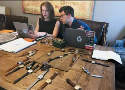  ?? THE ASSOCIATED PRESS ?? Watches lie on a table in front of Christian Zeron as he talks with Anna Griffin in Westfield, N.J. Zeron’s company website, theoandhar­ris. com, sells $2 million worth of watches annually. Regularly Zeron gets hundreds of thousands of views for his four weekly video posts on YouTube.